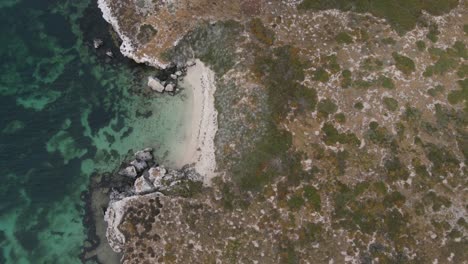 Descending-aerial-top-down-of-luxury-deserted-bay-with-crystal-clear-ocean-water-In-Margaret-River,-Western-Australia