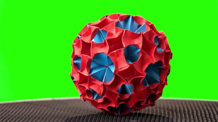 Creative origami ball on green screen.