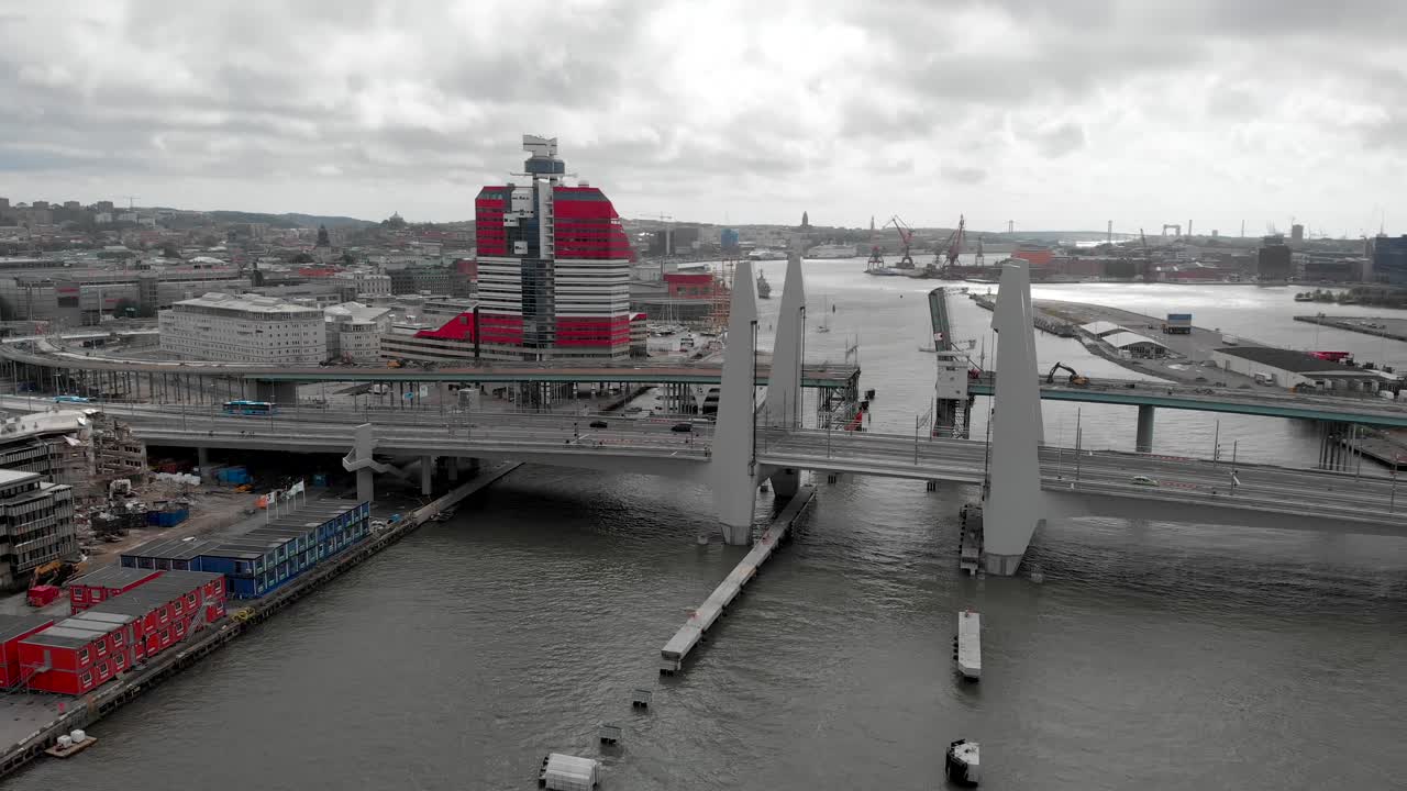 Newly constructed structure in Gothenburg, the modern Gota river crossing, Hisingsbron bridge against overcast sky background - aerial dolly out shot