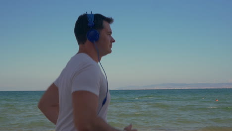 man jogging with music at the seaside