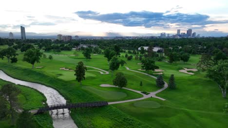 aerial descending shot over cherry creek in denver country club