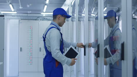 electrician working on electrical equipment in a server room