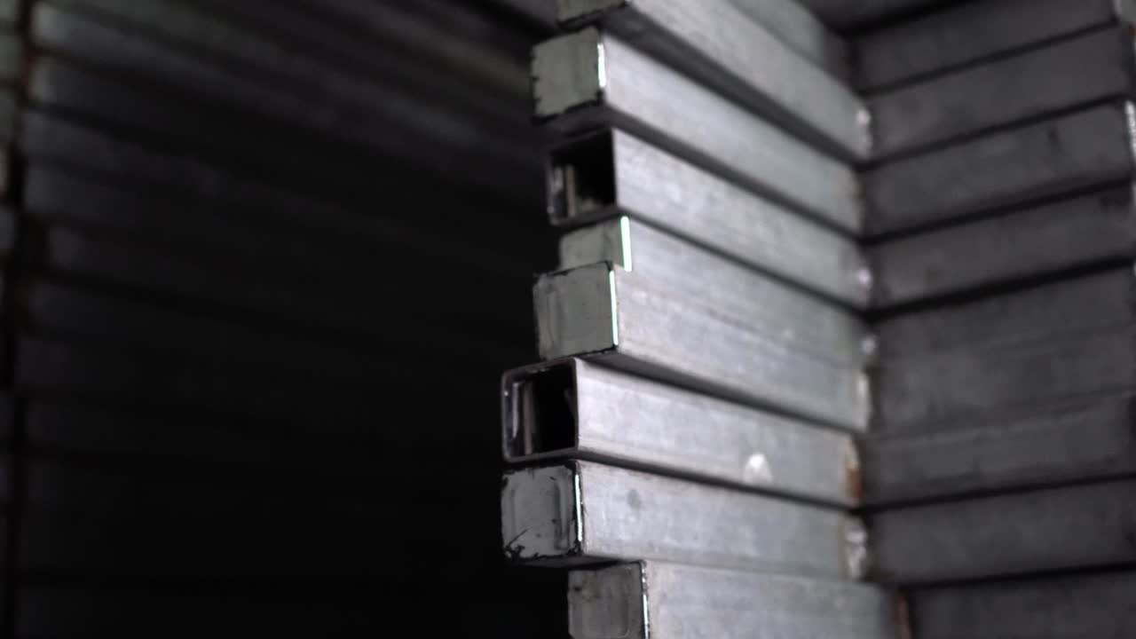 Metal recyclables are neatly arranged. Appearance is old. Tilt shot from top to bottom.