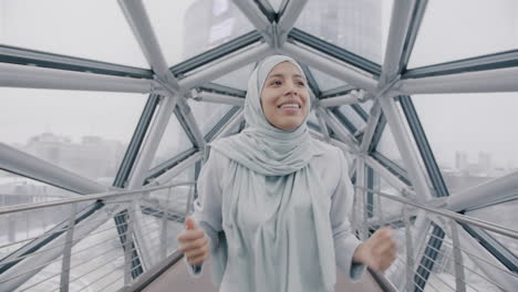 joyful woman in hijab on a modern bridge