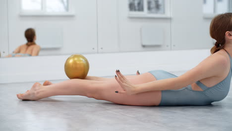 woman practicing gymnastics or dance with exercise ball