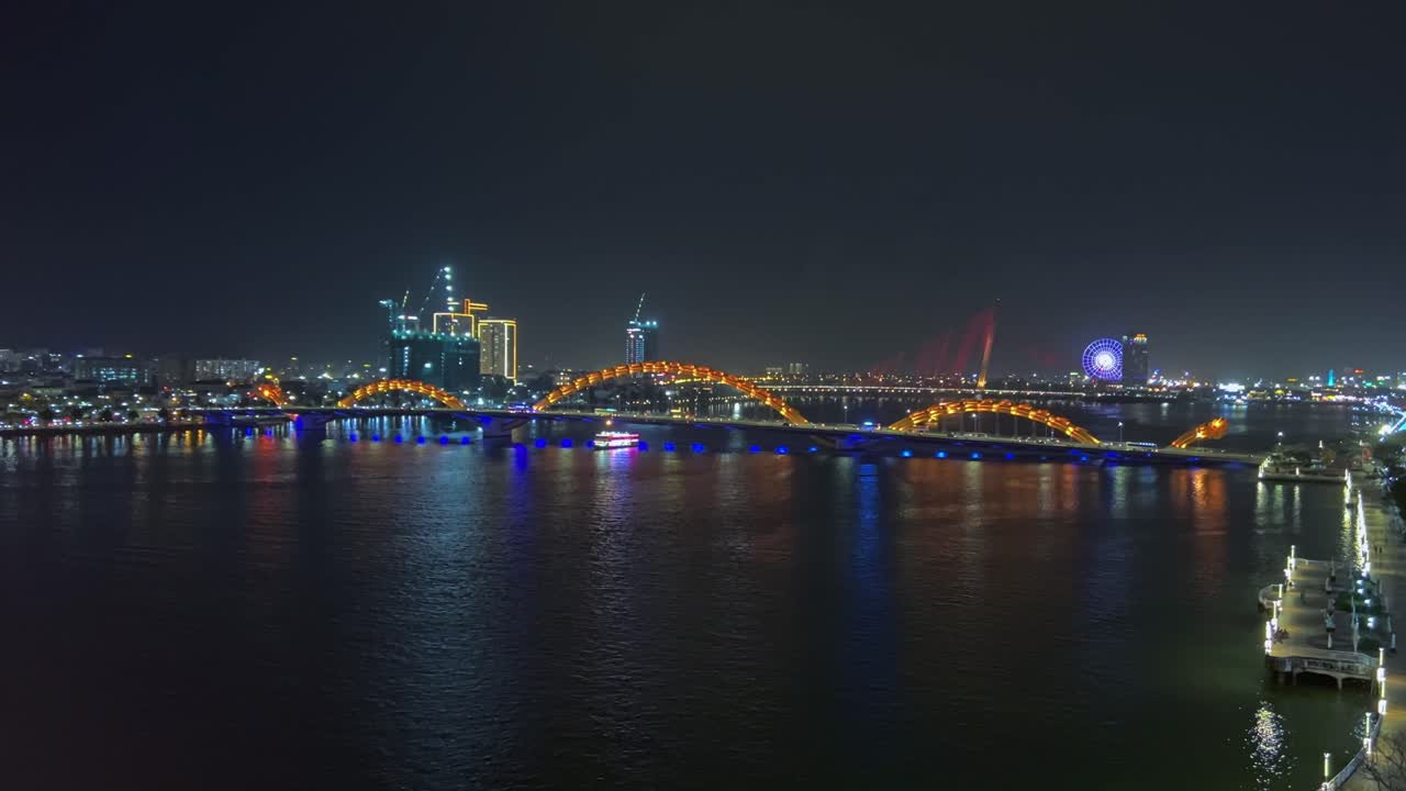 Famous Dragon Bridge With Colorful Lights At Night Crossing River Han In Danang, Vietnam. wide static shot