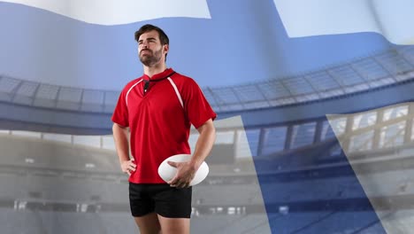 jugador de rugby profesional de pie frente a una bandera y un estadio