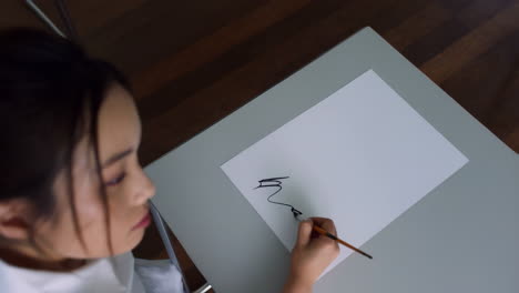 woman practicing calligraphy or drawing