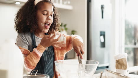 a young girl having fun baking in the kitchen