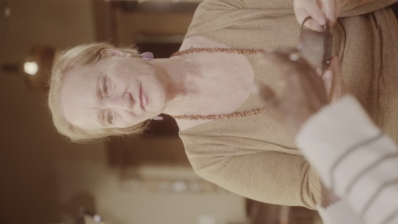 Elderly woman interacting and holding glasses