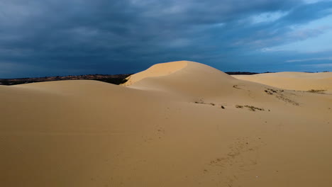 stunning white sand dunes with moody sky in mui ne, vietnam