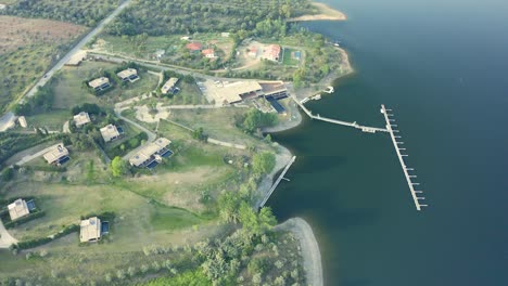 aerial view towards clube naútico montargil, that is temporarily closed because of the covid in a amazing sunset, alentejo, montargil