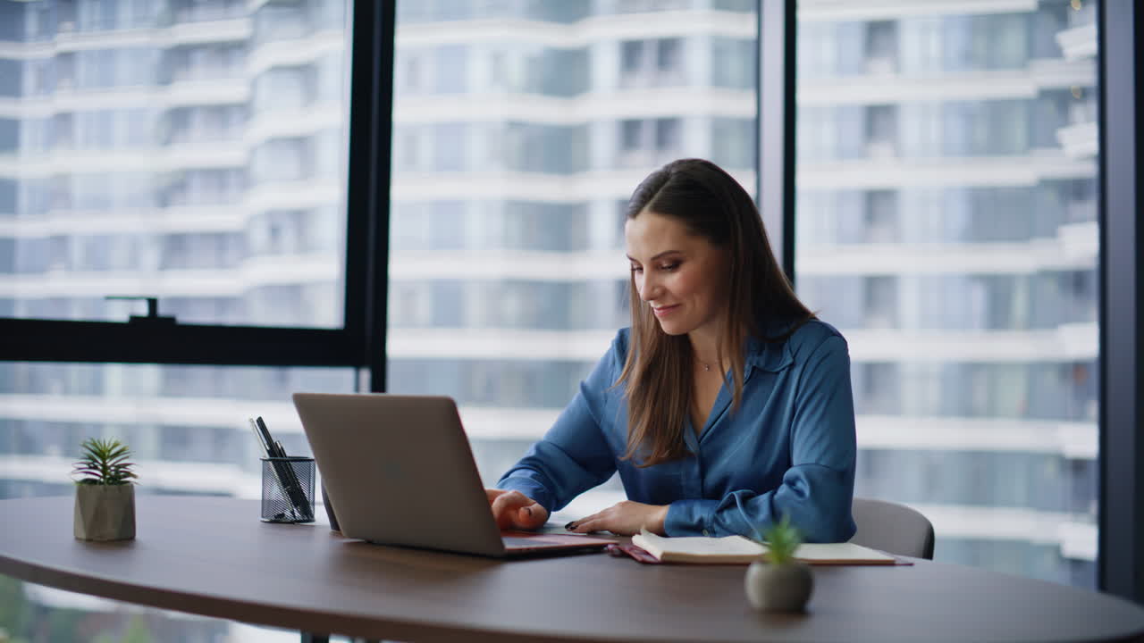 Job candidate talking online meeting sitting modern workplace. Smiling woman
