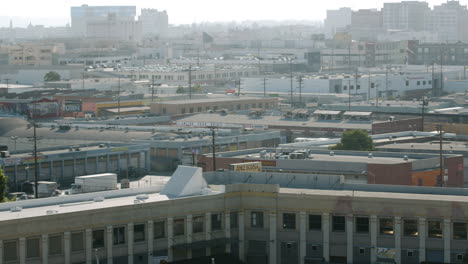 aerial view of a sprawling urban landscape with numerous buildings under a hazy sky