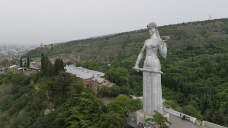 aerial dolly in shot of the massive mother of georgia monument in tbilisi