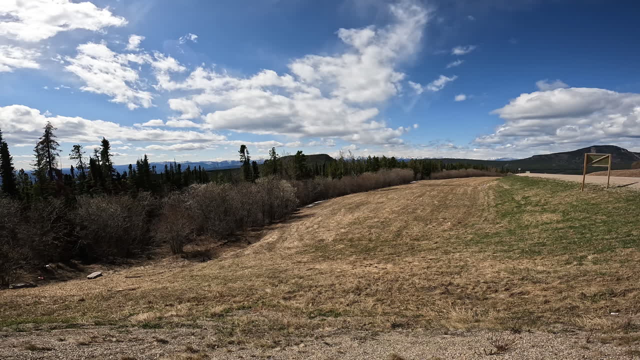 Panoramic view of the Muskwa River Valley with boreal forest and Rocky Mountains in northern British Columbia in early spring; concepts of adventure travel and road less traveld