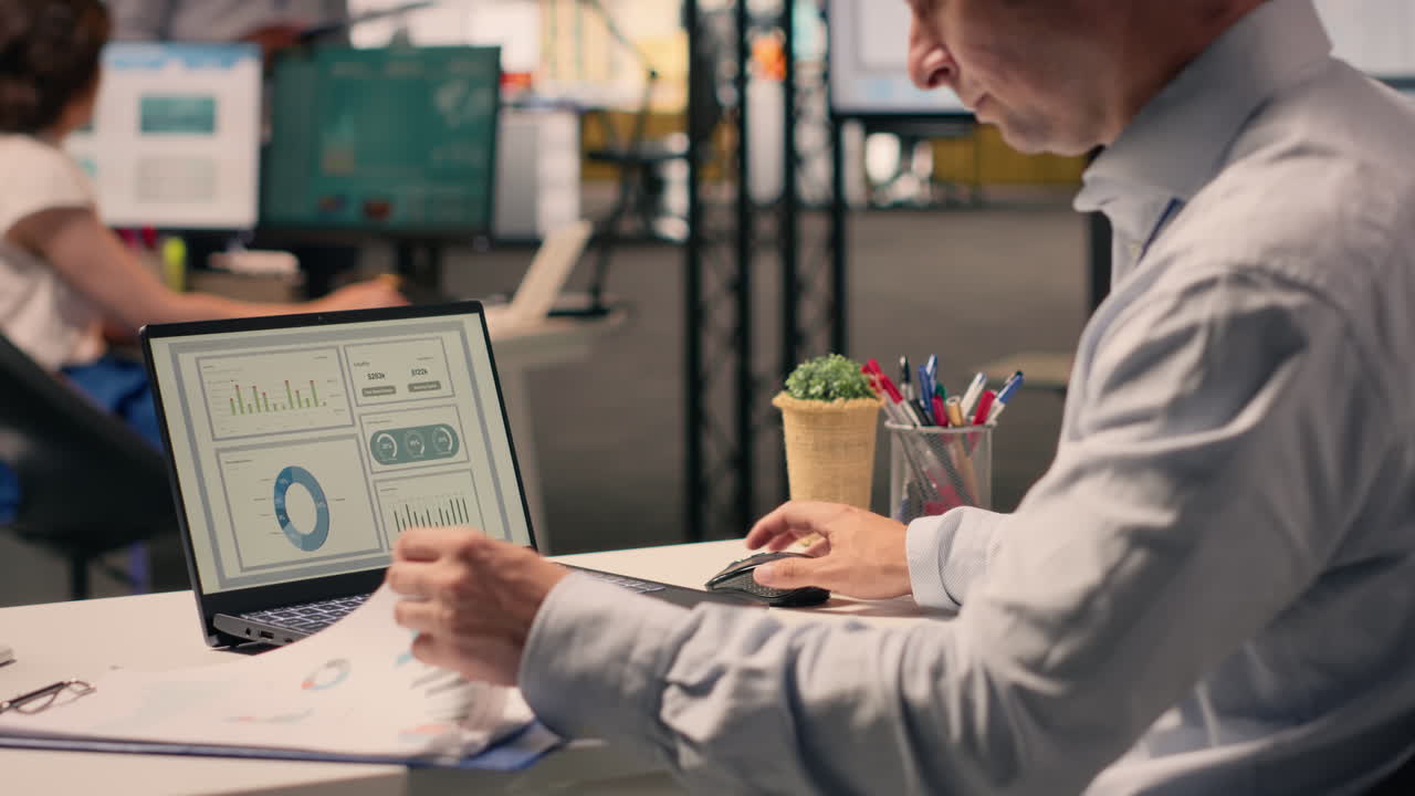 Corporate lifestyle scene with man reviewing KPI metrics and data analysis