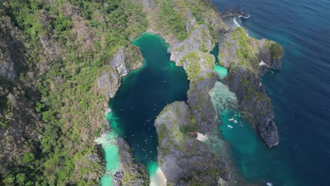 sweeping aerial view high above small and big lagoon of el nido, philippines