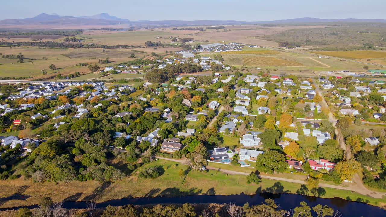 Sunset drone view of Stanford town in South African countryside next to river