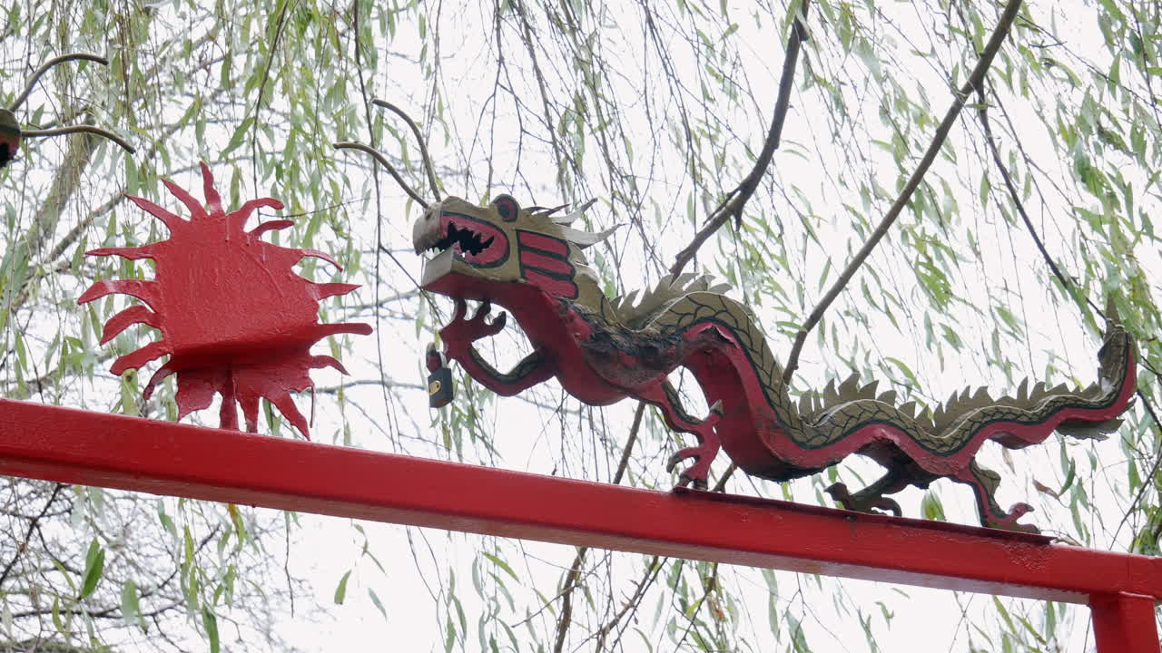 A Chinese dragon and sun decoration in a garden