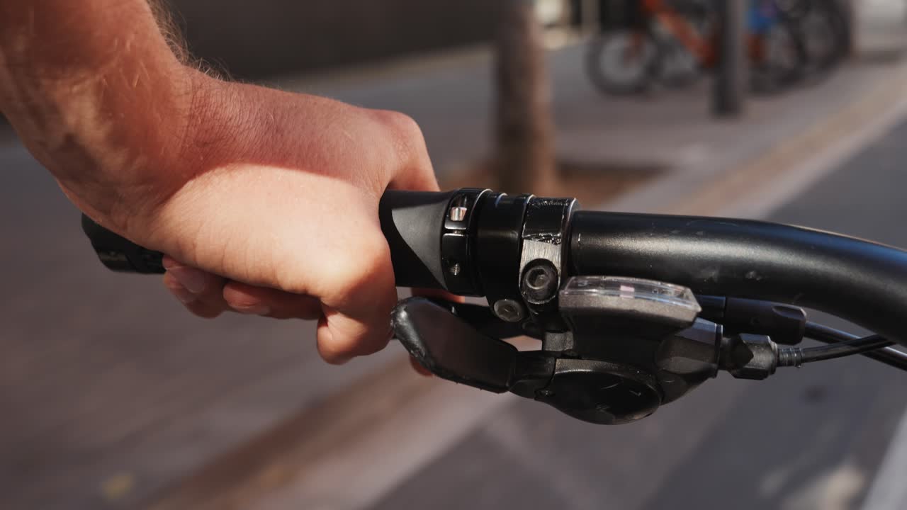 Hand on a bicycle handlebar