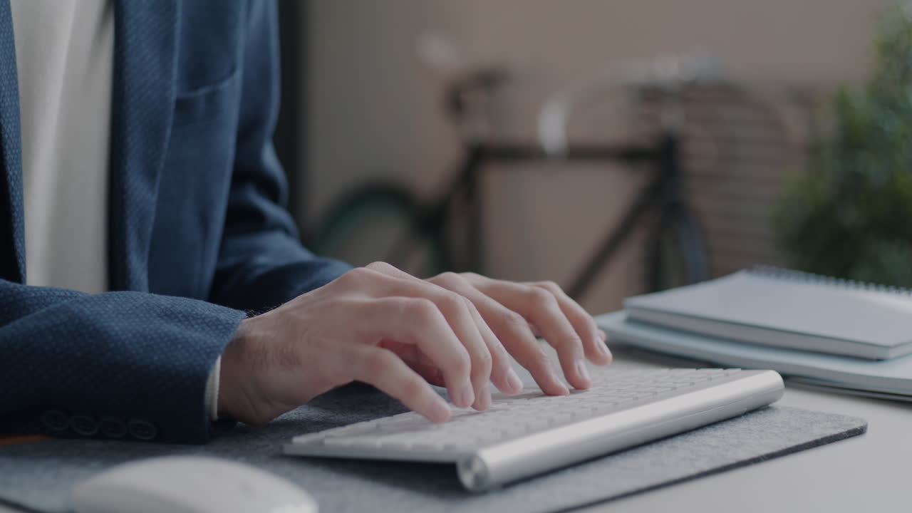 Businessman Typing on Keyboard in Office