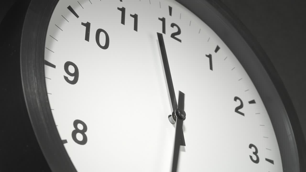 Clock Face in Time Lapse on Dark Grey Wall