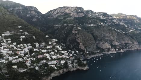 Wide-drone-shot-of-Praiano,-Italy-with-homes-built-on-the-steep-hillside