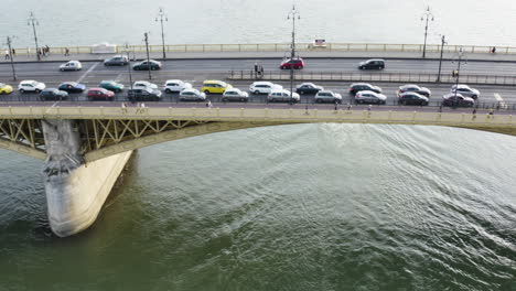 aerial - margaret bridge on the danube river, budapest, hungary, truck left