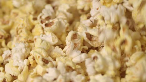 mixing hot popcorn in heap. close up of fresh popcorn flakes. popping up popcorn