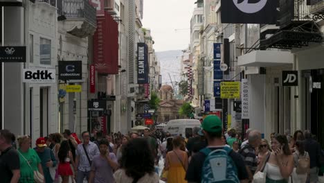 busy shopping street in athens with many people walking