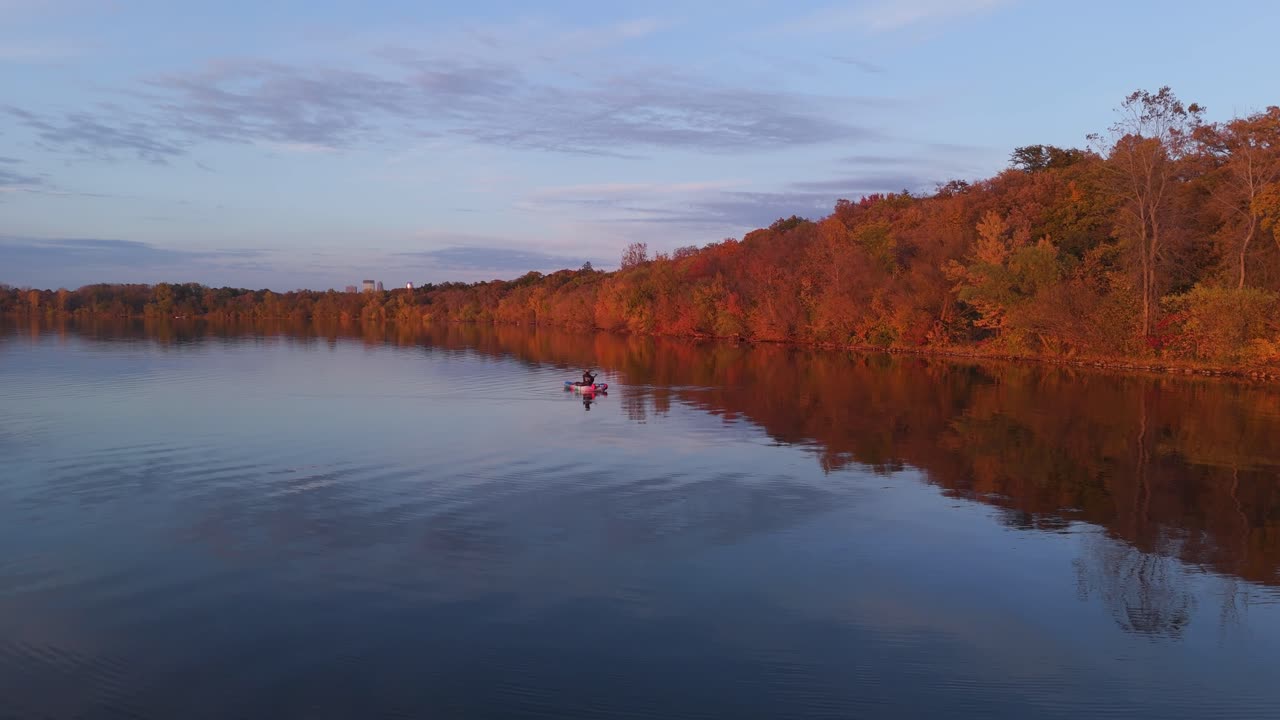 Golden hour bathes Lake Calhoun and surrounding autumn trees, creating a stunning aerial perspective
