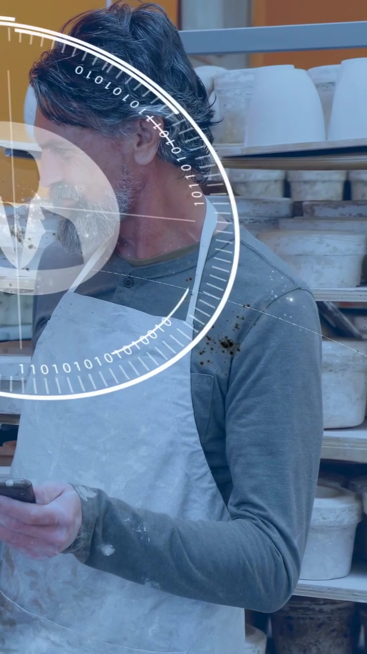 Vertical video: Man bringing phone, activating HUD over pottery molds, showing info to colleague