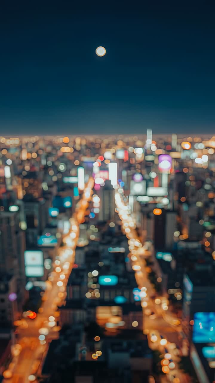 Vertical video: Sequence starting aerial view tilting down over lit avenue at night, with full moon