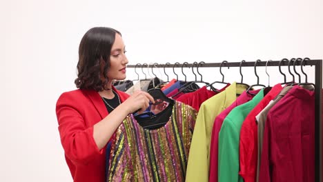 woman shopping and selecting clothes from a colorful rack