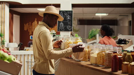 client examines cereals and grains at zero waste eco store