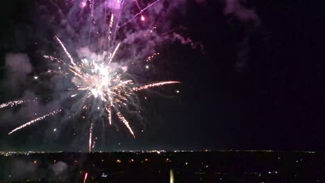 fireworks flying up and going off at night