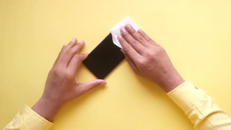 cleaning a smartphone with a wipe