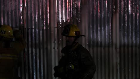 fireman cutting hole in building for ventilation