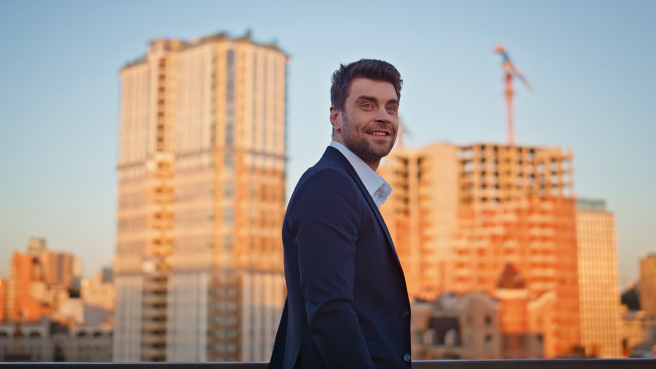 Confident businessman standing terrace contemplating sunset skyline closeup