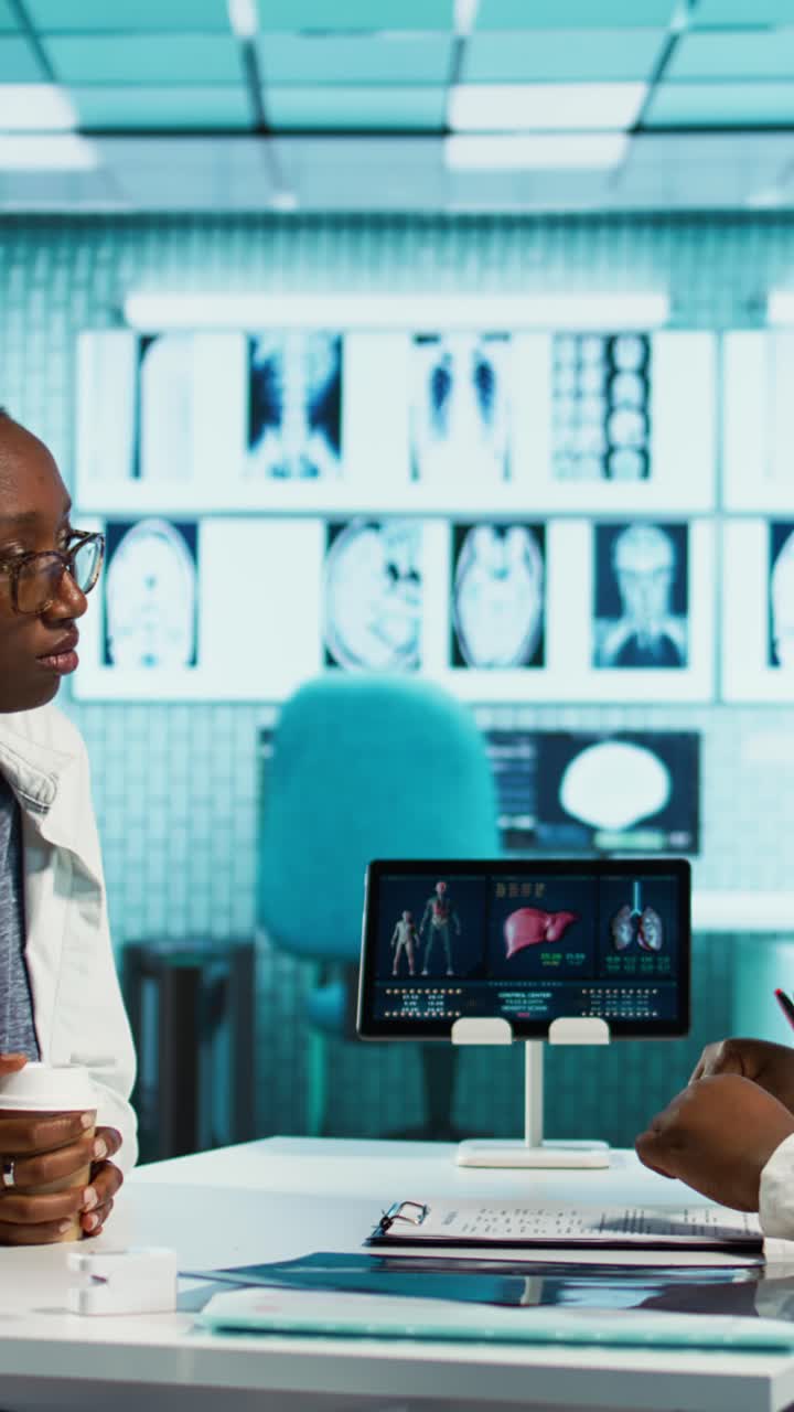African American Doctor Explaining Medical Data to Patient on Digital Tablet