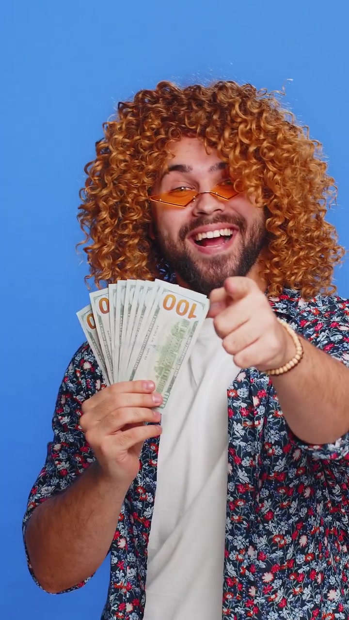Rich happy man winner waving money dollar cash like a fan big income wealth success business