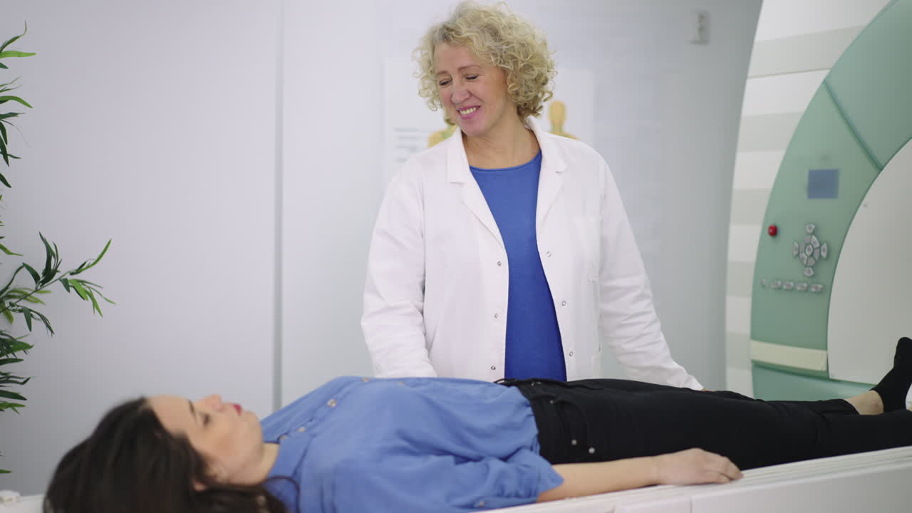 Doctor assists patient with MRI scan