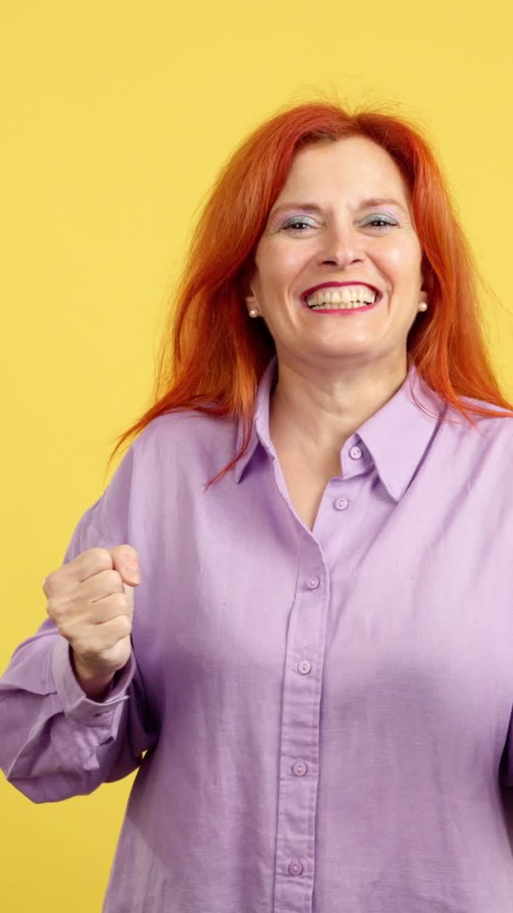 Ecstatic Red-Haired Woman Celebrating Success