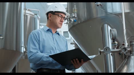 engineer inspecting brewery equipment
