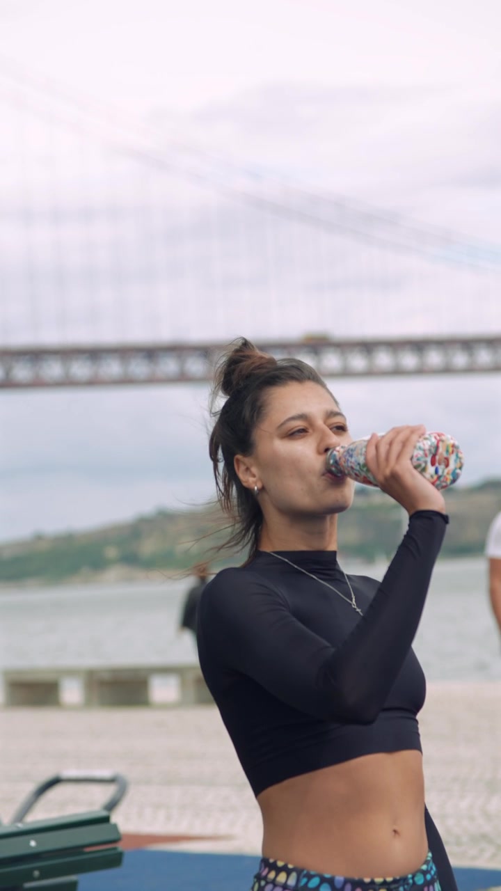 Young Woman Hydrating with a Water Bottle Outdoors