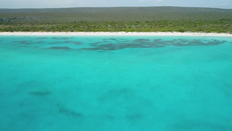 Aerial-backward-over-sea-at-Bahia-de-las-Aguilas,-Dominican-Republic