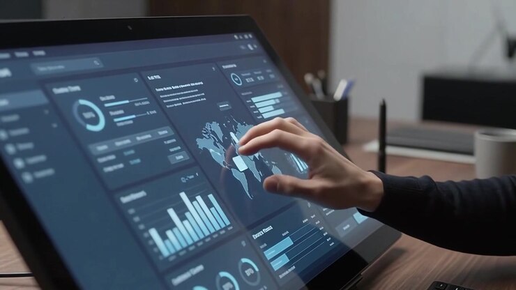 Professional Man Analyzing Data on Touchscreen Monitor in Office