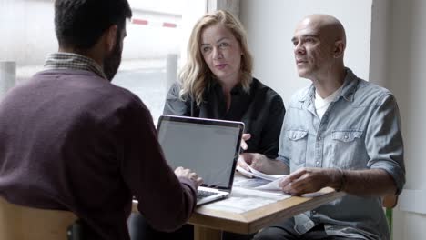 three confident planners discussing new project