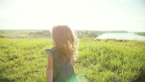 little girl walking in a meadow